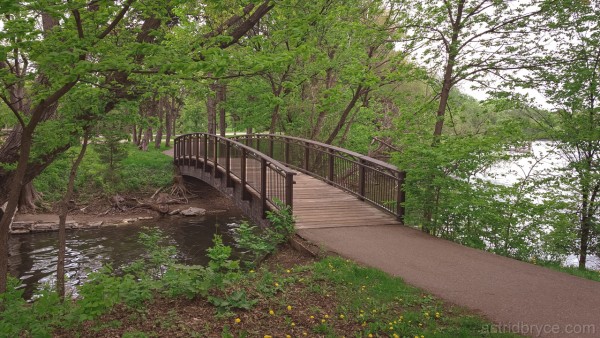 A wooden bridge crosses a spur of Minnehaha Creek around Lake Nokomis